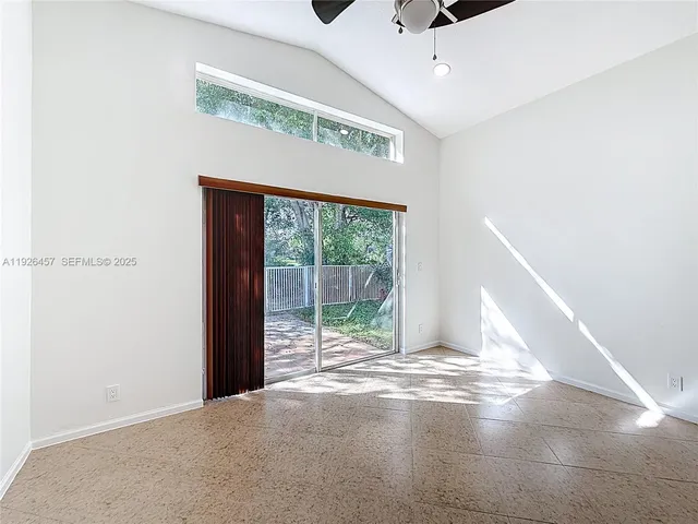 a view of a livingroom with a ceiling fan and window