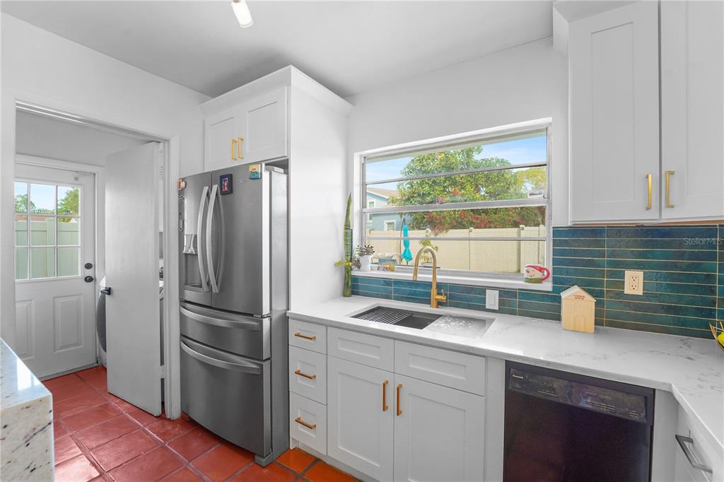 7523 Barry Road Tampa, FL 33634 - Photo 13 of 28 a kitchen with a refrigerator and a sink