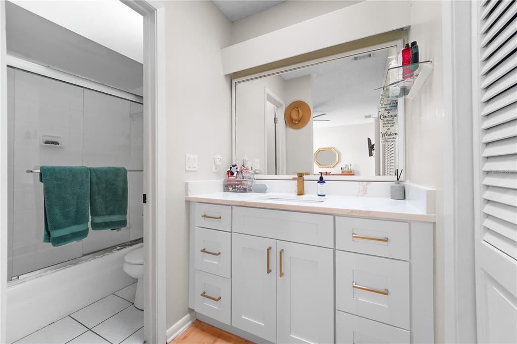 7523 Barry Road Tampa, FL 33634 - Photo 20 of 28 a bathroom with a double vanity sink mirror and toilet
