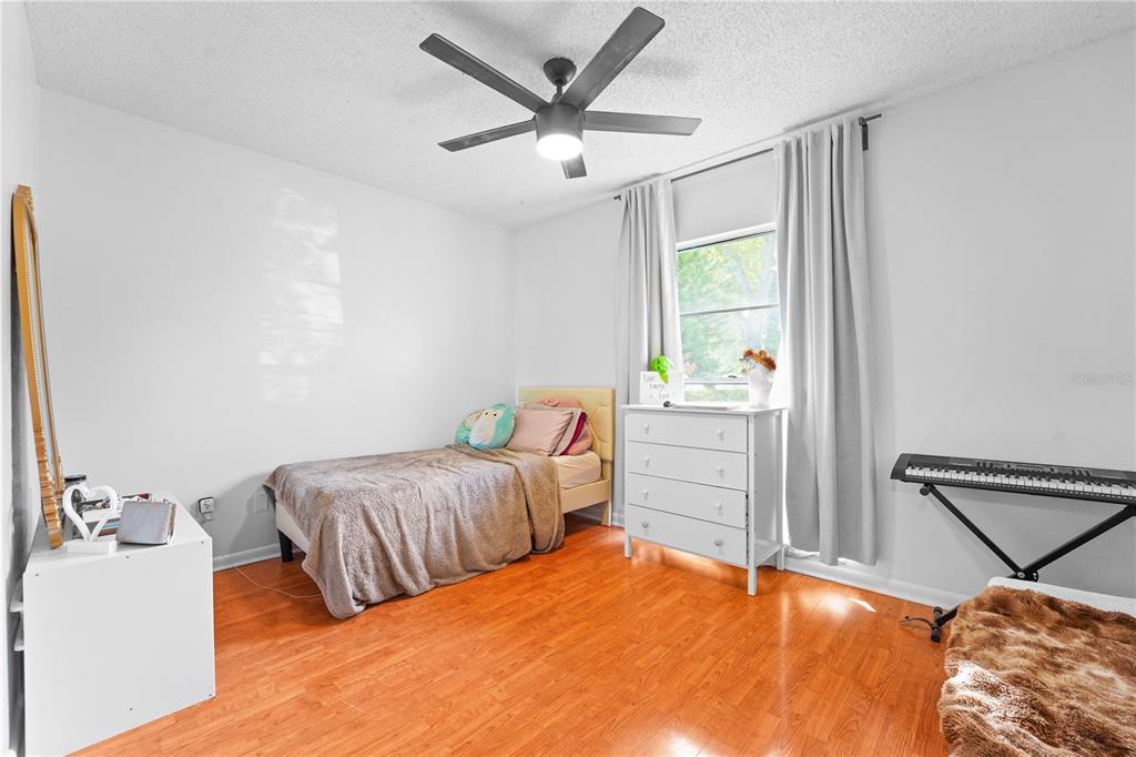 7523 Barry Road Tampa, FL 33634 - Photo 21 of 28 a bedroom with two beds and a window
