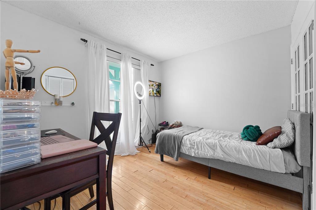 7523 Barry Road Tampa, FL 33634 - Photo 24 of 28 a bed room with a bed and a desk