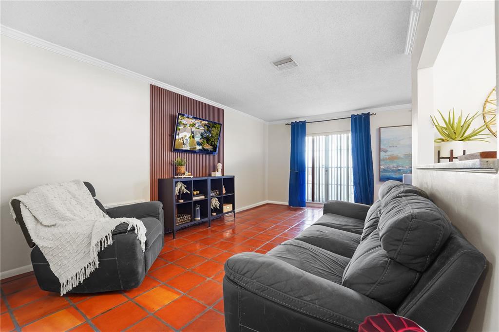 7523 Barry Road Tampa, FL 33634 - Photo 7 of 28 a living room with furniture ceiling fan and a window
