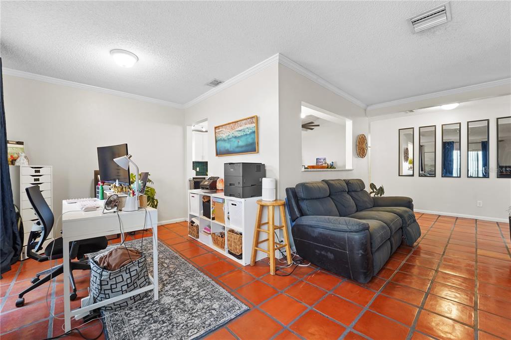7523 Barry Road Tampa, FL 33634 - Photo 9 of 28 a living room with furniture and a rug