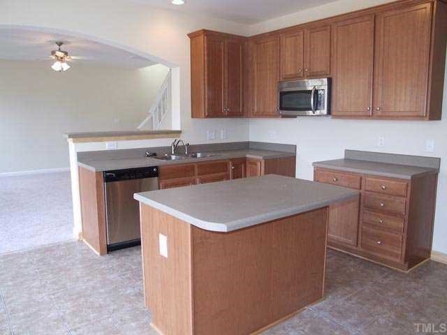 2215 Stoney Spring Drive Raleigh, NC 27610 - Photo 12 of 12 a kitchen with stainless steel appliances granite countertop a stove a sink and a microwave
