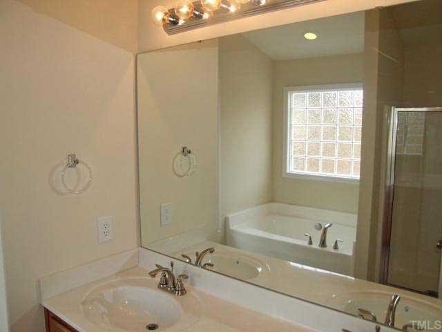 2215 Stoney Spring Drive Raleigh, NC 27610 - Photo 9 of 12 a bathroom with a sink and a bathtub