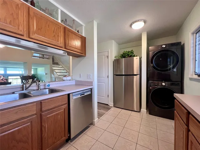 a kitchen with a refrigerator a sink and cabinets