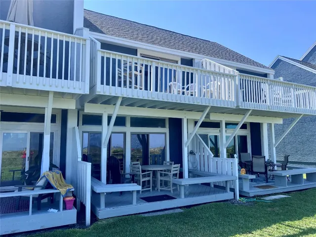 a view of a house with patio and a yard