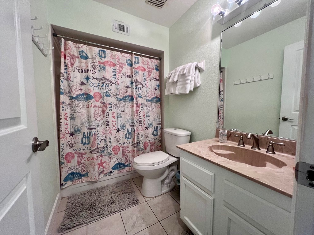 95118 Sandpiper Loop Fernandina Beach, FL 32034 - Photo 24 of 35 a bathroom with a sink a toilet and shower curtain