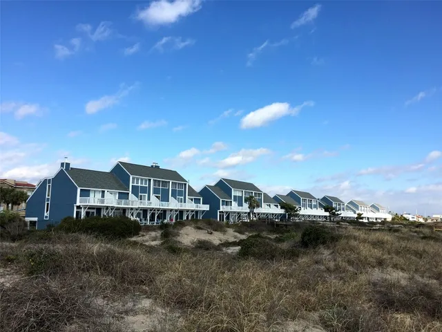 a view of a house with a yard and sitting area