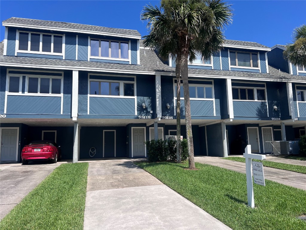 95118 Sandpiper Loop Fernandina Beach, FL 32034 - Photo 34 of 35 a front view of a house with a yard and potted plants