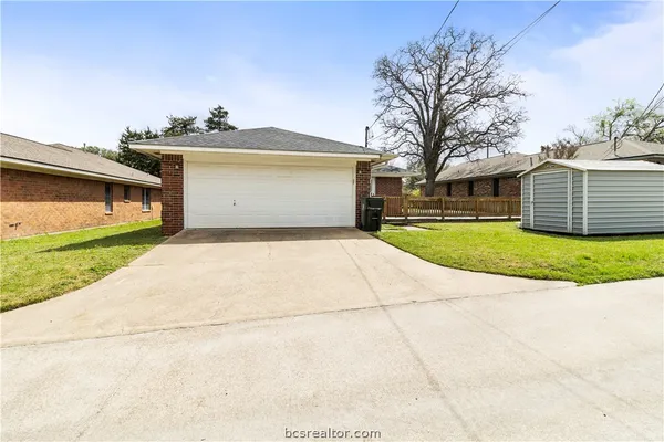 a view of a house with a yard and garage
