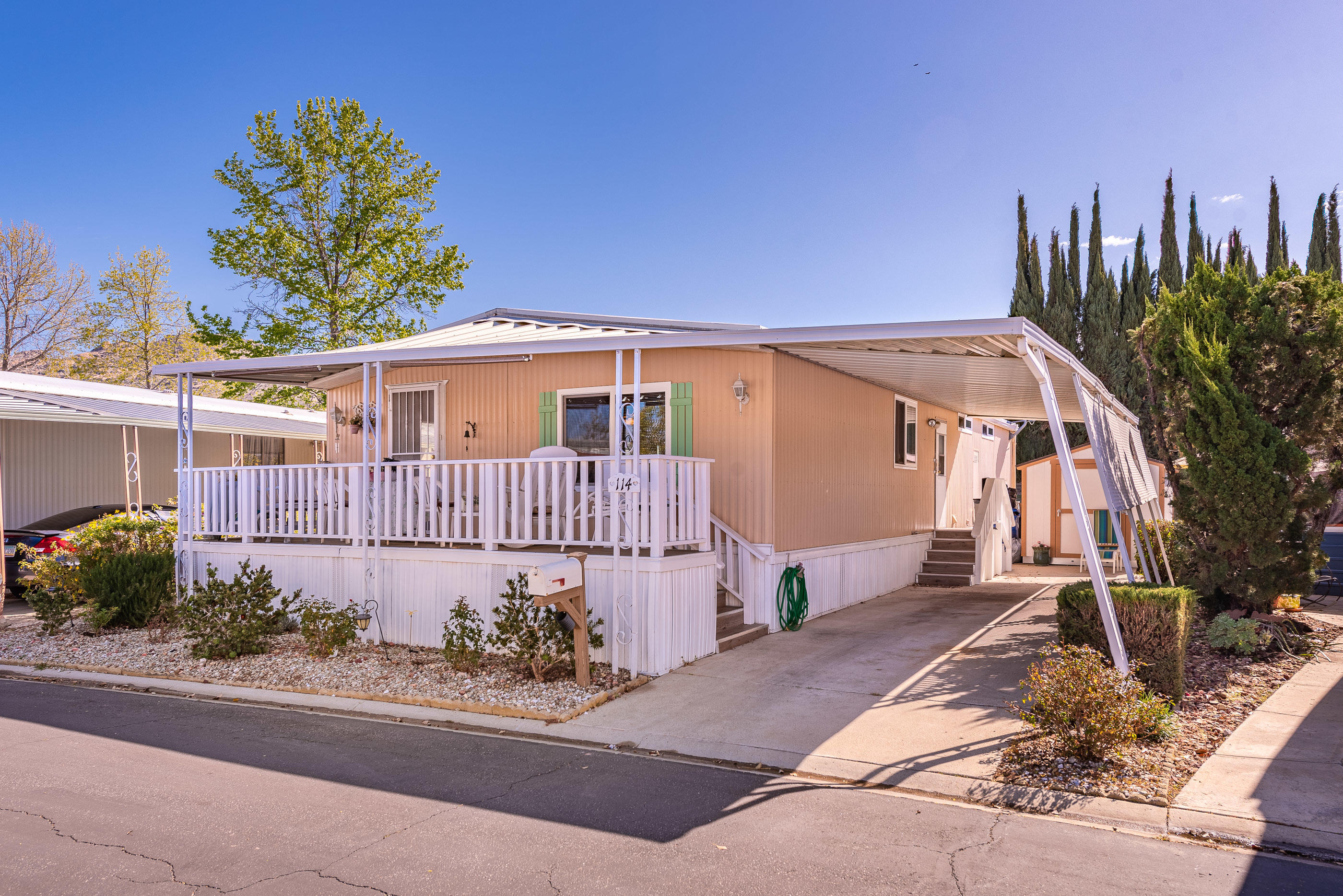 6480 Katherine Road, Unit 114 Simi Valley, CA 93063 - Photo 1 of 25 a view of a house with a yard and potted plants
