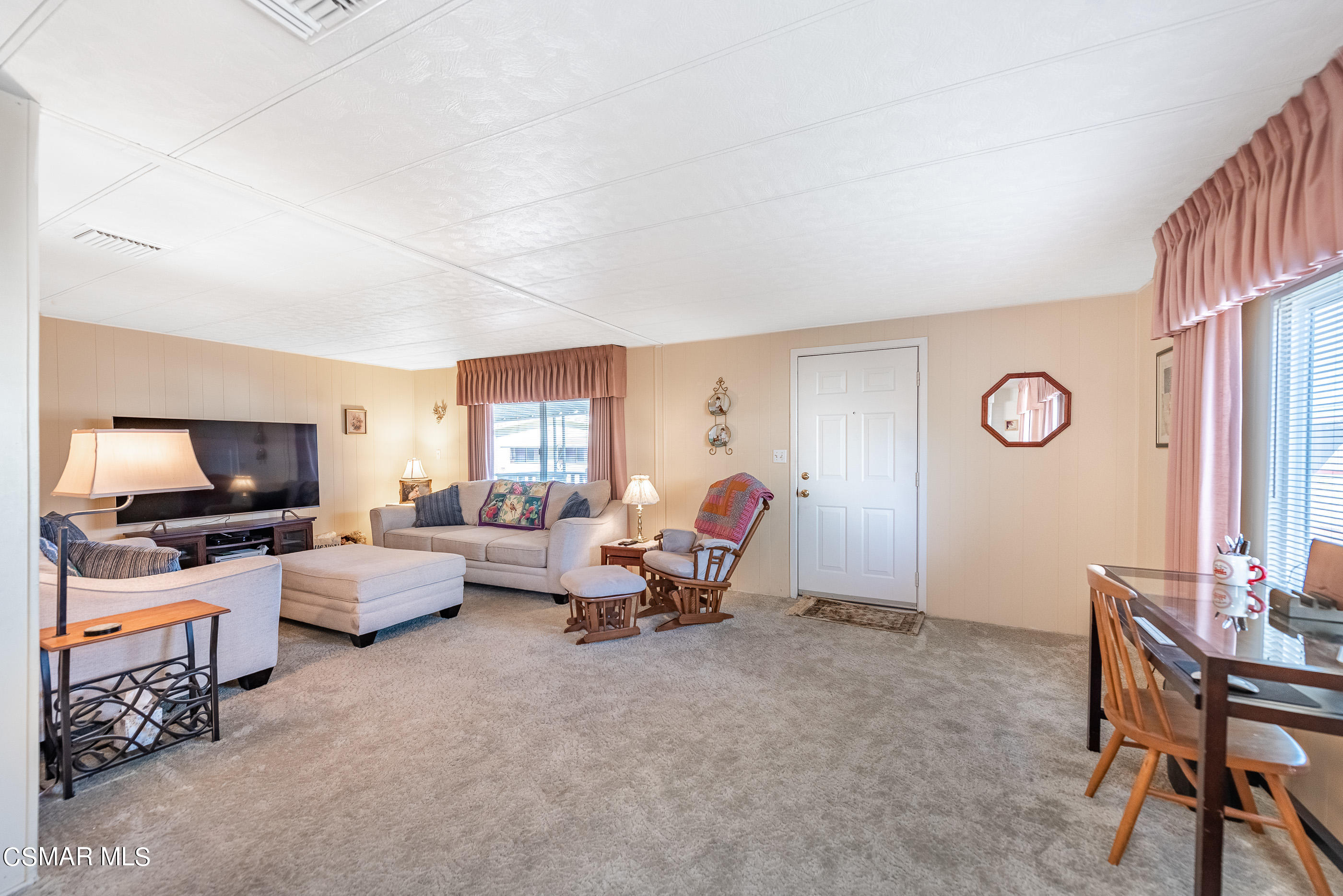 6480 Katherine Road, Unit 114 Simi Valley, CA 93063 - Photo 5 of 25 a living room with furniture and a flat screen tv