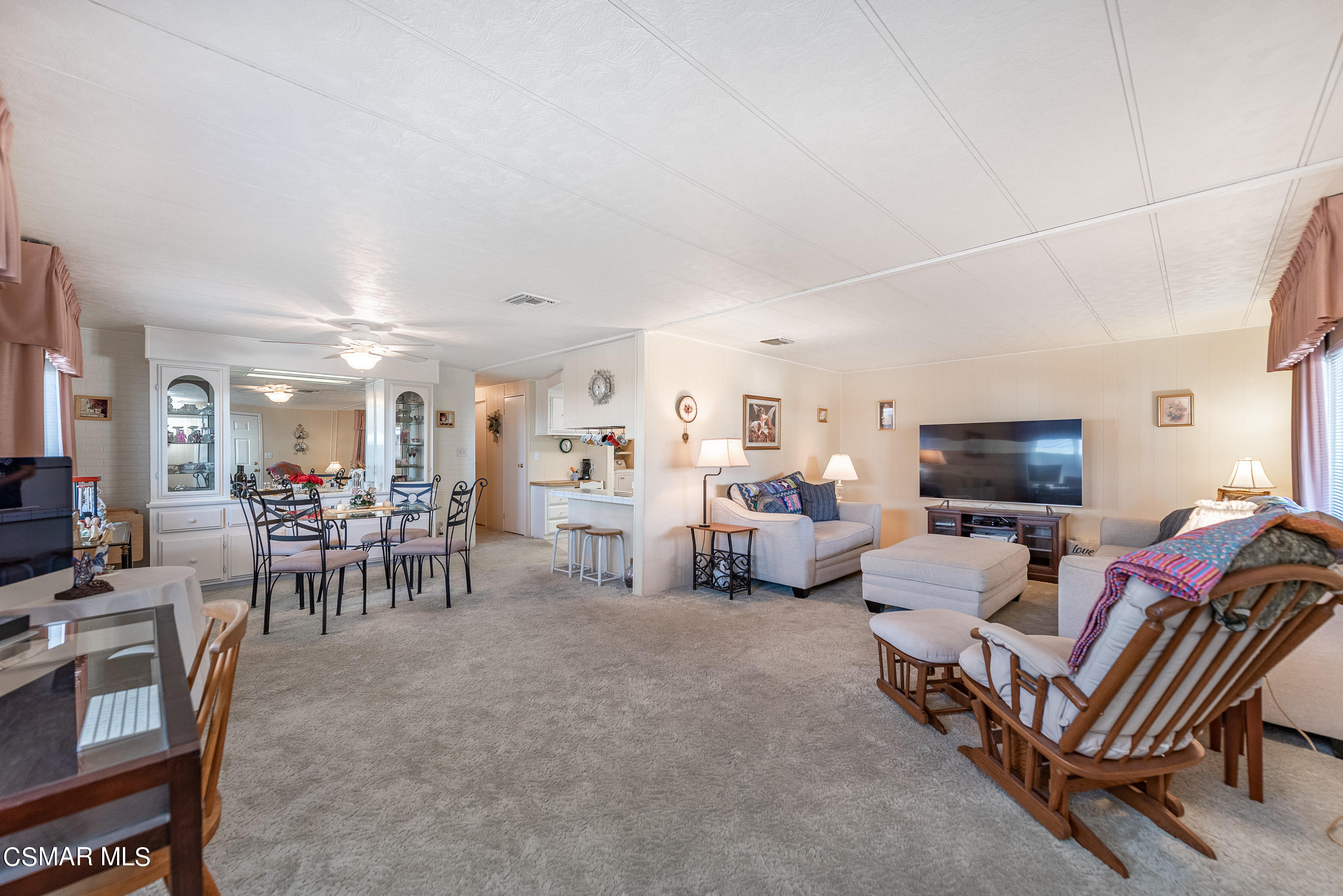 6480 Katherine Road, Unit 114 Simi Valley, CA 93063 - Photo 6 of 25 a living room with furniture and a flat screen tv
