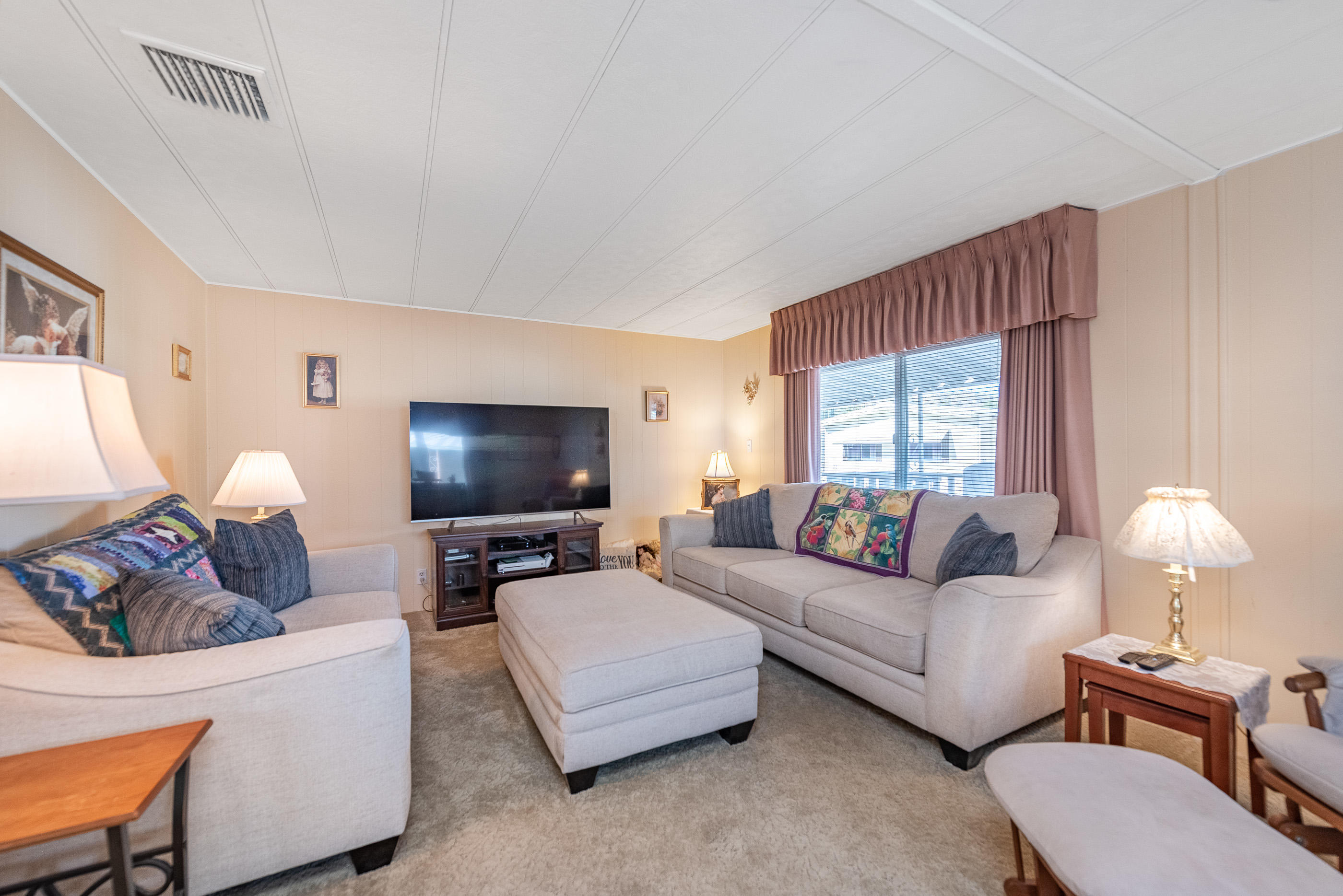 6480 Katherine Road, Unit 114 Simi Valley, CA 93063 - Photo 7 of 25 a living room with furniture and a flat screen tv