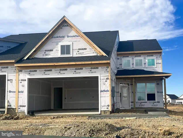 a view of a house with wooden walls and entryway