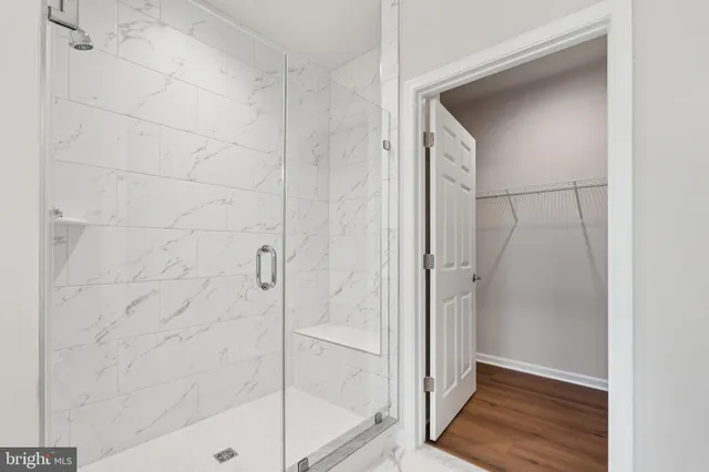 a bathroom with a glass shower door