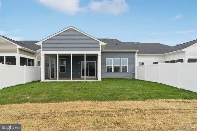 a view of a house with a yard and potted plants