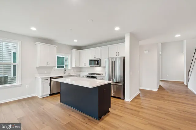 a kitchen with stainless steel appliances a sink stove and refrigerator