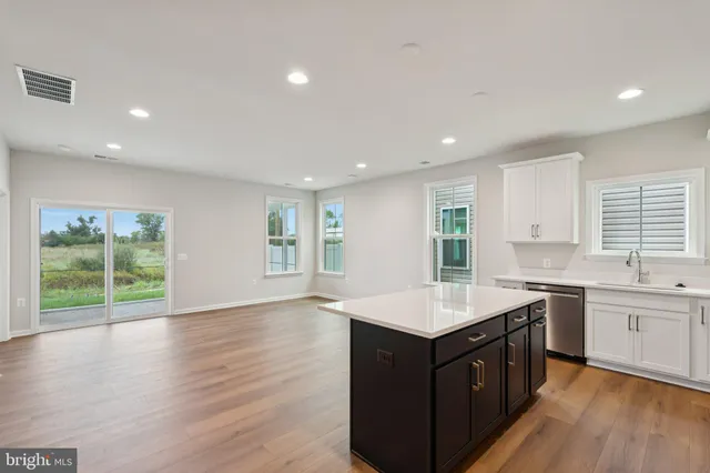 a kitchen with a sink window and cabinets