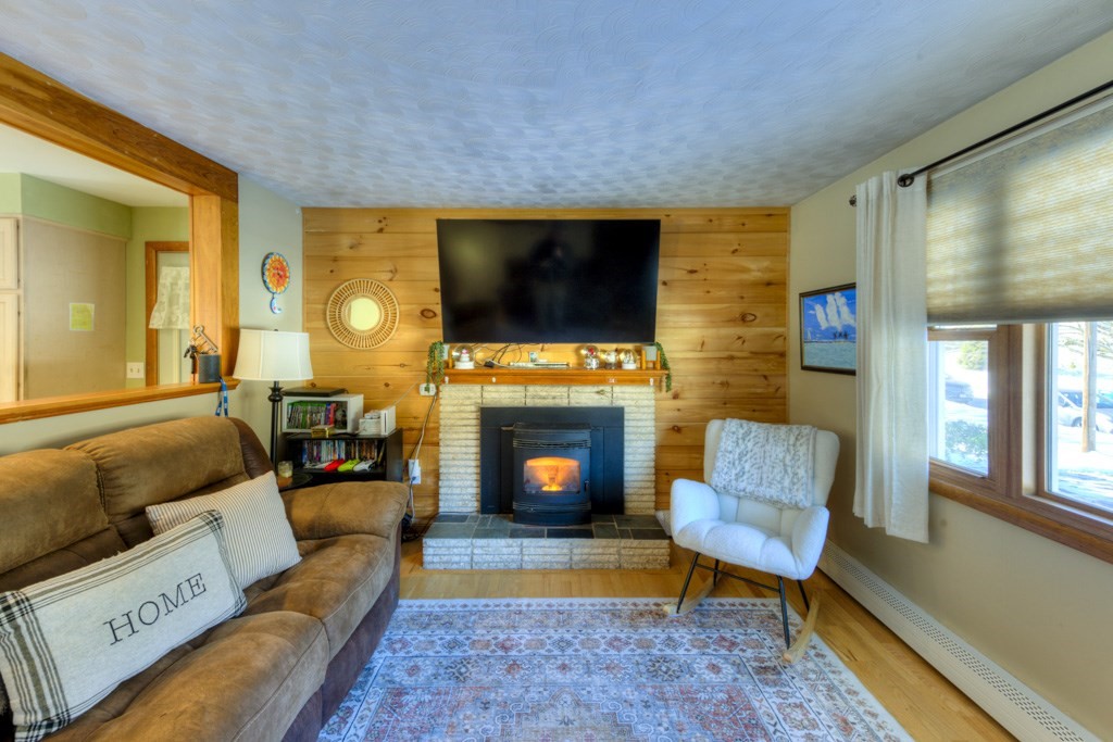 13 Anthony Drive Rutland, MA 01543 - Photo 15 of 40 a living room with furniture a flat screen tv and a fireplace