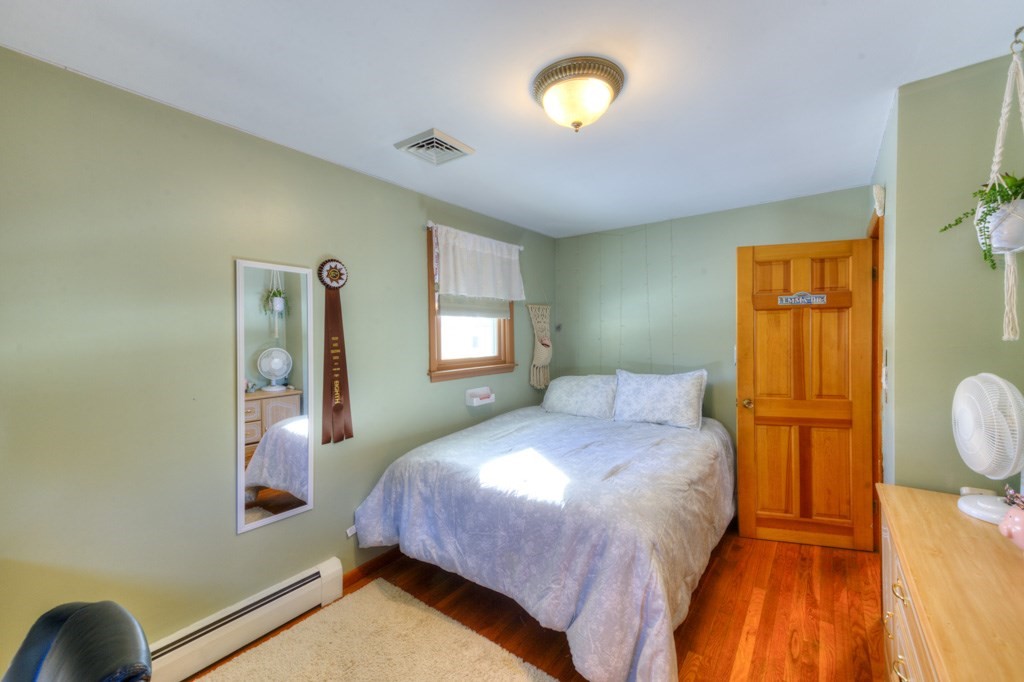 13 Anthony Drive Rutland, MA 01543 - Photo 23 of 40 a bedroom with a bed and wooden floor