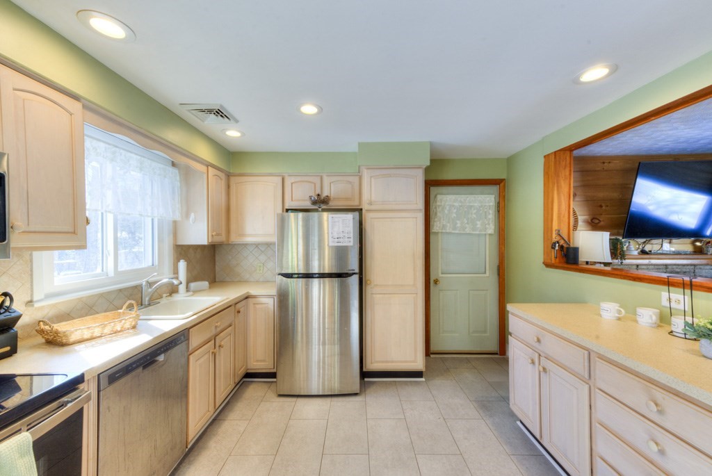 13 Anthony Drive Rutland, MA 01543 - Photo 6 of 40 a kitchen with a refrigerator a sink and a stove top oven