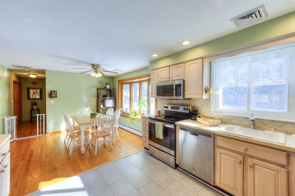 13 Anthony Drive Rutland, MA 01543 - Photo 8 of 40 a kitchen with stainless steel appliances granite countertop a stove top oven a sink a dining table and chairs