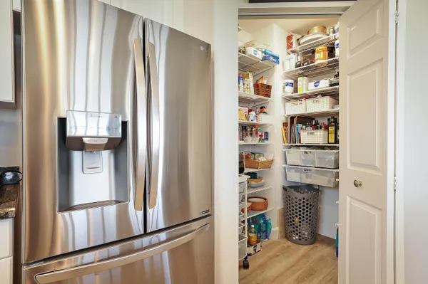 a kitchen with granite countertop a stove a sink a dining table and chairs