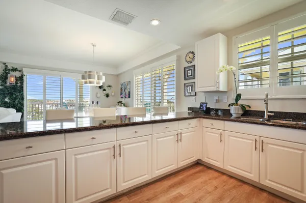a kitchen with granite countertop cabinets stainless steel appliances a sink and window