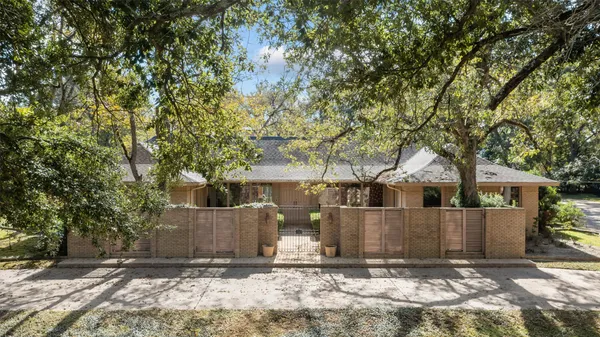 front view of a house with a large tree