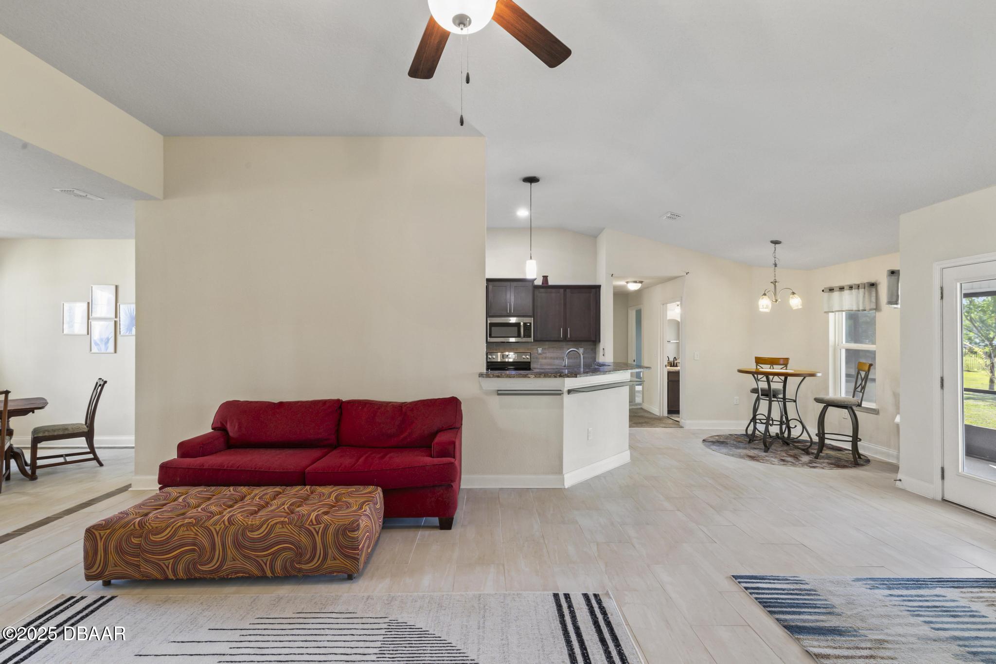 66 Eagle Lake Drive Flagler Beach, FL 32136 - Photo 13 of 77 a living room with furniture and kitchen view
