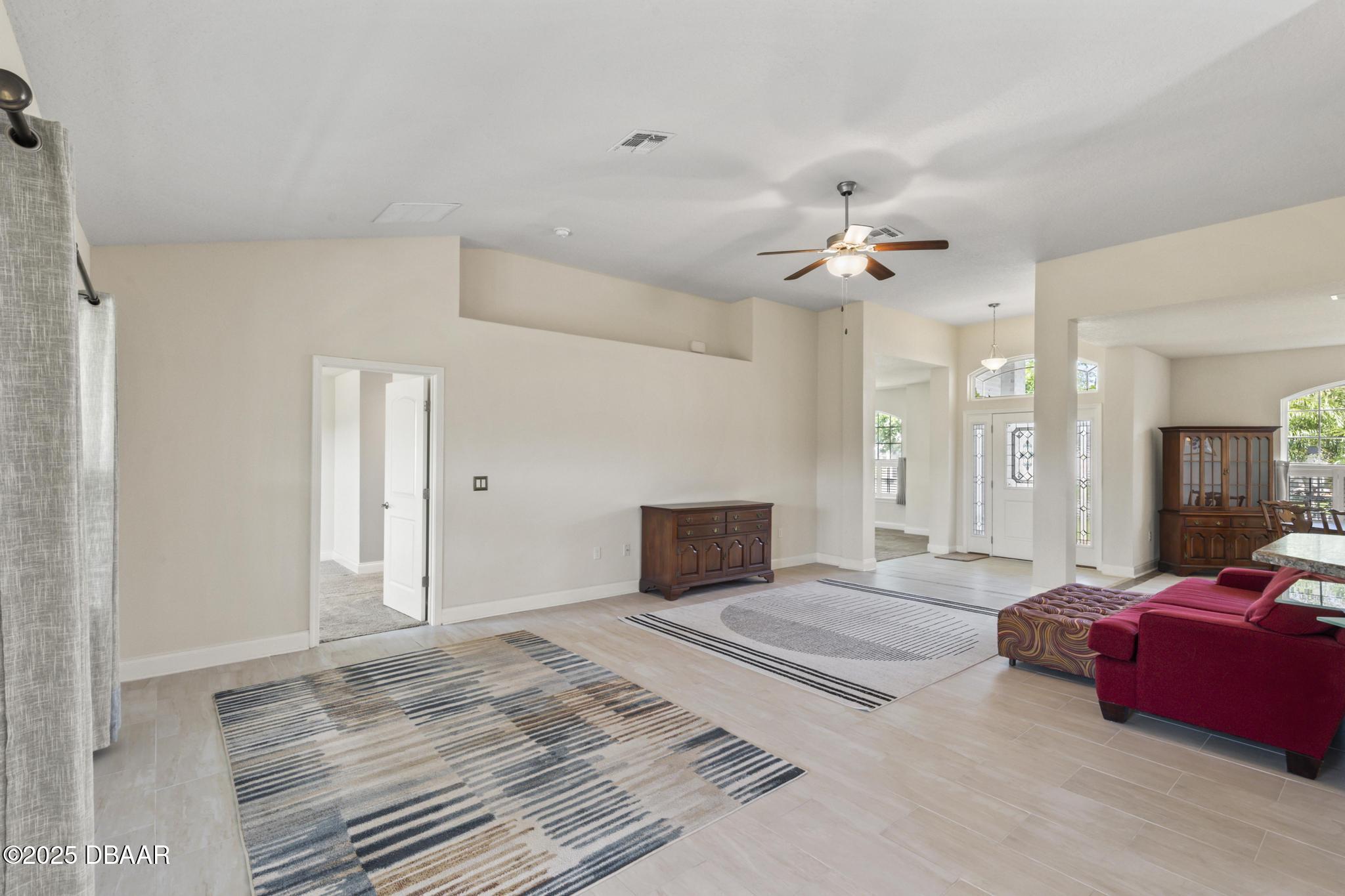 66 Eagle Lake Drive Flagler Beach, FL 32136 - Photo 15 of 77 a spacious bedroom with a bed and a chandelier