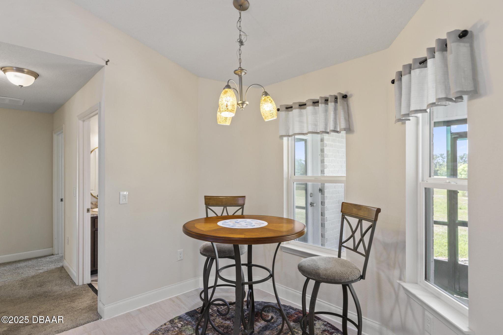 66 Eagle Lake Drive Flagler Beach, FL 32136 - Photo 25 of 77 a view of a room with furniture and a chandelier