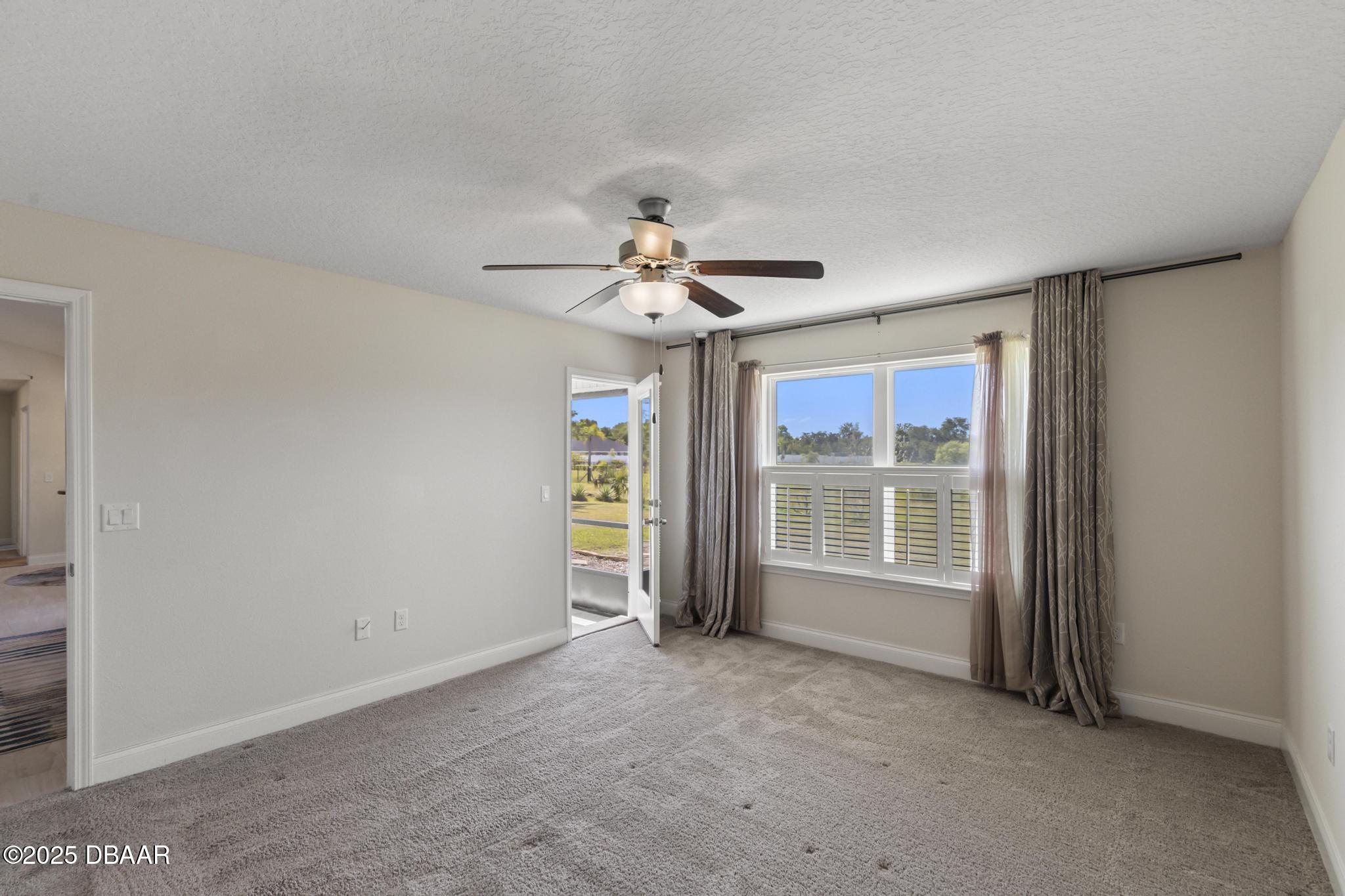 66 Eagle Lake Drive Flagler Beach, FL 32136 - Photo 28 of 77 an empty room with windows and ceiling fan