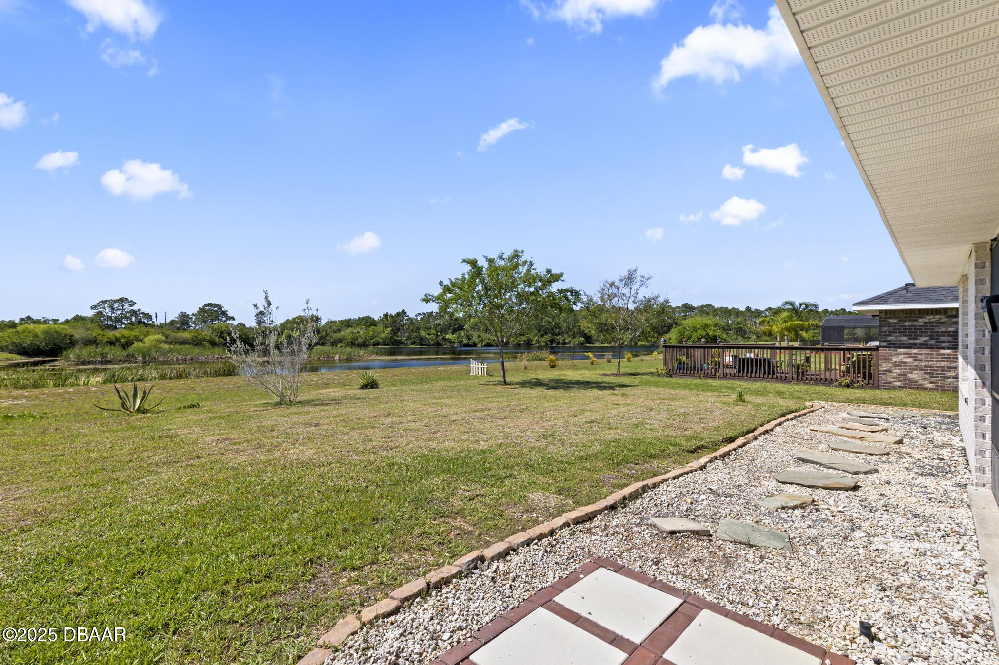 66 Eagle Lake Drive Flagler Beach, FL 32136 - Photo 46 of 77 a view of a lake from a yard