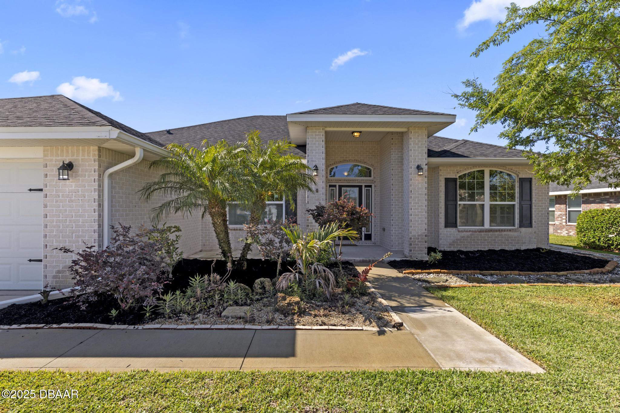 66 Eagle Lake Drive Flagler Beach, FL 32136 - Photo 54 of 77 a front view of a house with garden