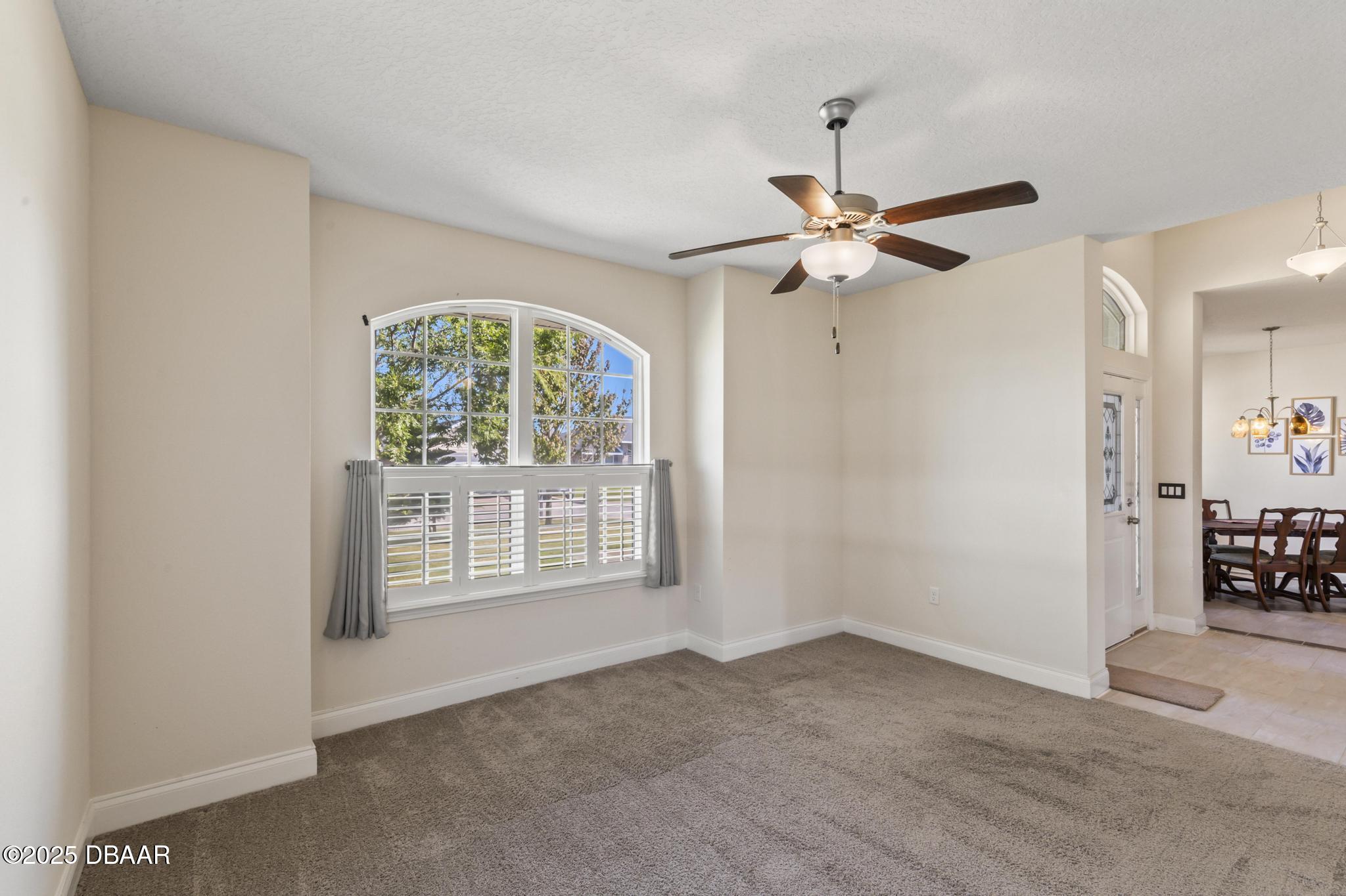 66 Eagle Lake Drive Flagler Beach, FL 32136 - Photo 9 of 77 a view of a livingroom with a window and a ceiling fan