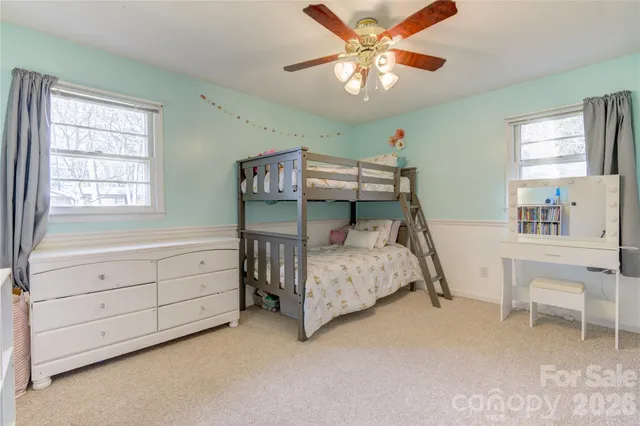 a bedroom with a bed and a table in it
