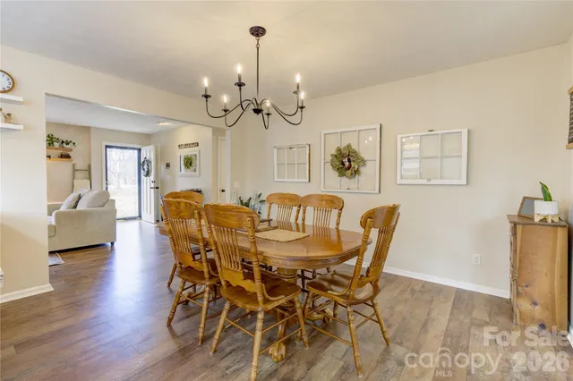a view of a dining room with furniture wooden floor and chandelier