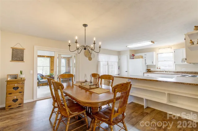 a view of a a dining room with furniture window and wooden floor
