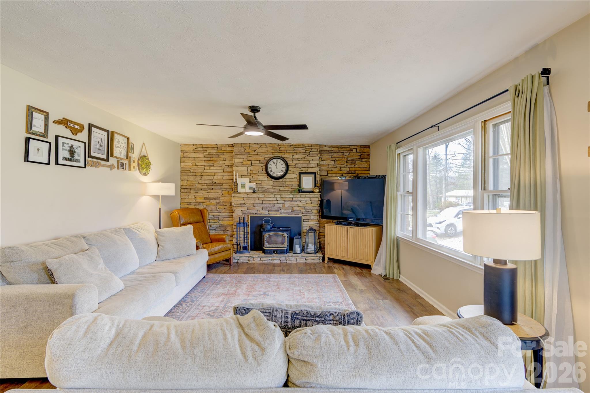 216 Castleton Lane Hendersonville, NC 28791 - Photo 9 of 22 a living room with furniture and a fireplace