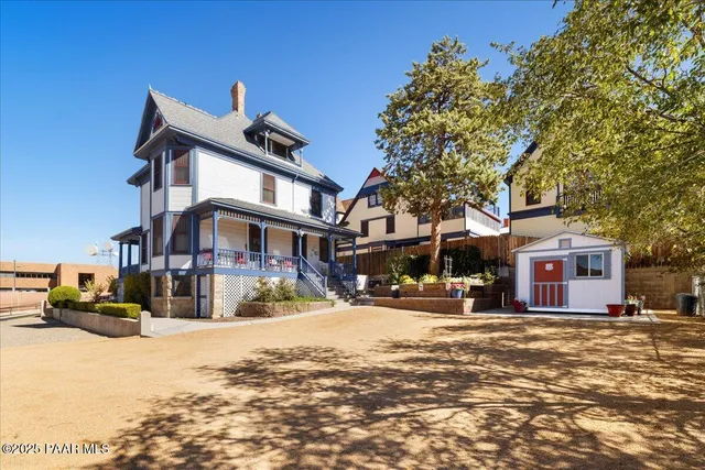 a front view of a house with a yard covered in snow