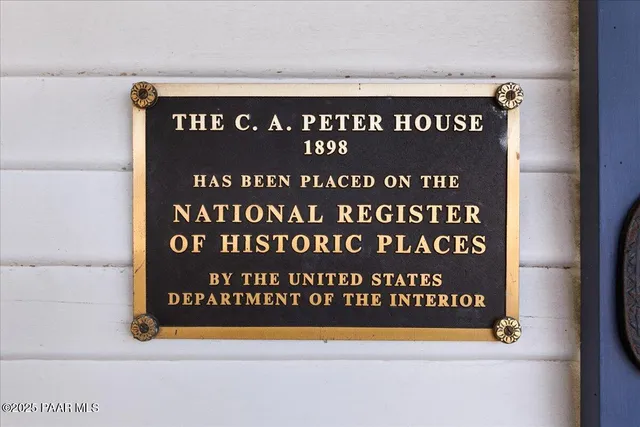 a front view of a house with a garden and plants
