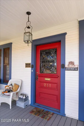 a view of staircase with railing and a chandelier