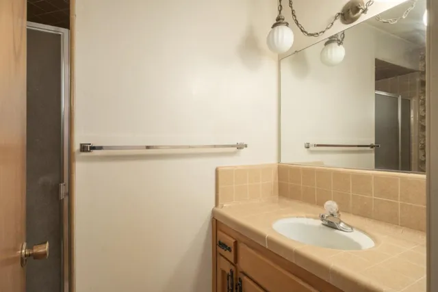 a patio with a table and chairs under an umbrella