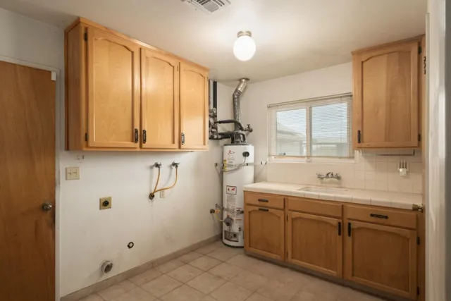 a view of back yard of the house with wooden fence