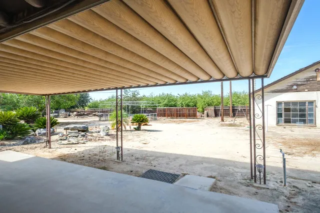 a view of a backyard with swimming pool