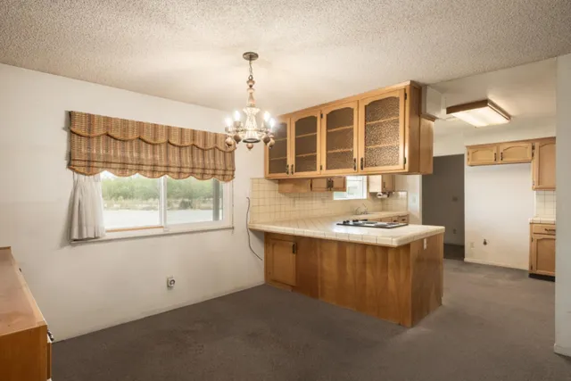 a kitchen with cabinets appliances and a sink