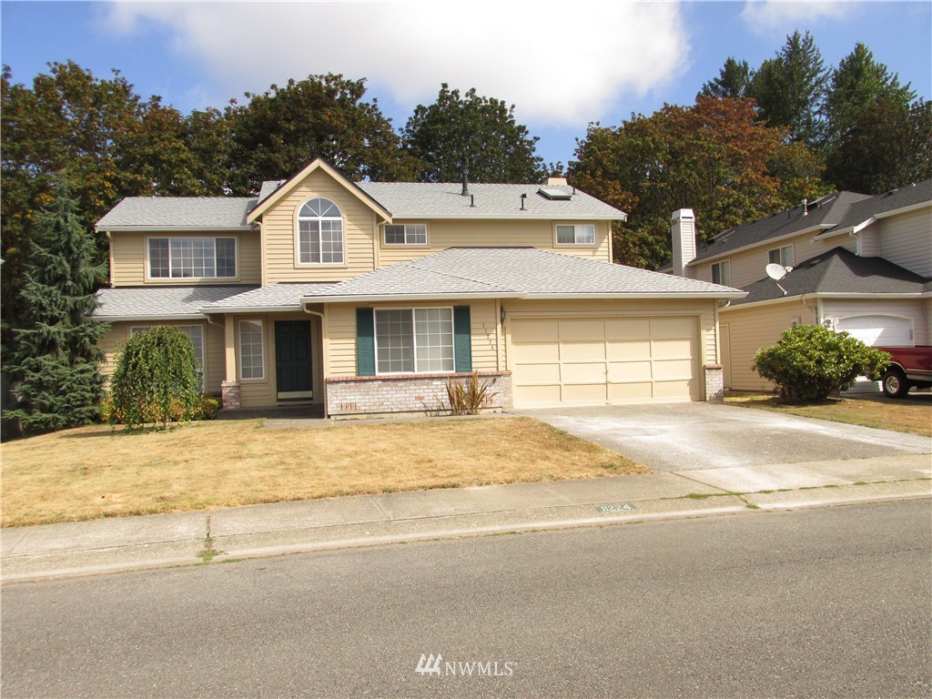 11224 Southeast 188th Place Renton, WA 98055 - Photo 15 of 16 a front view of a house with a yard and garage